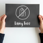 holding a dairy free sign