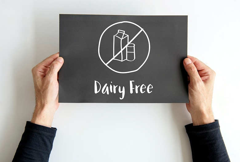 holding a dairy free sign